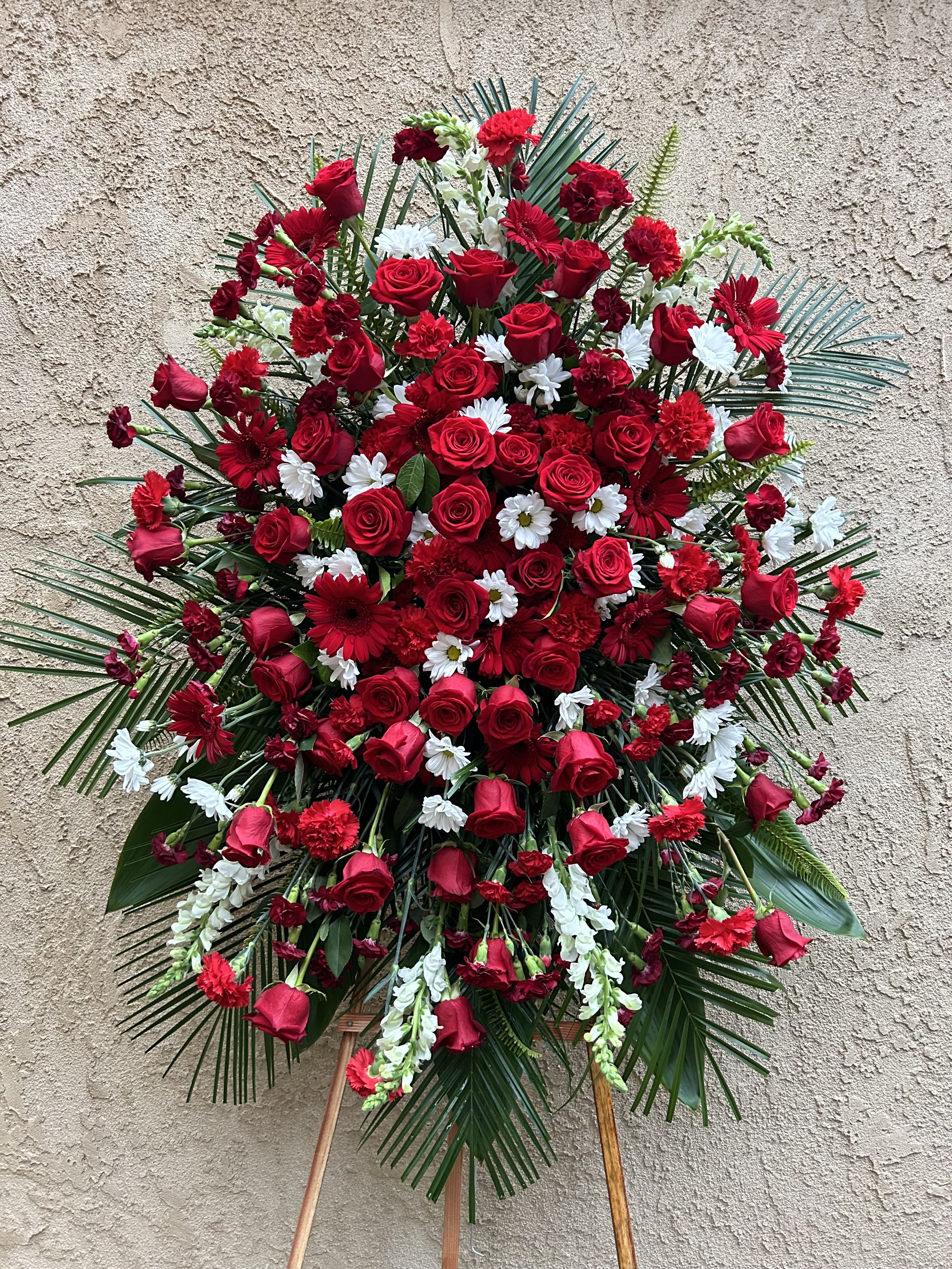 Everlasting - Beautiful red spray arrangement featuring roses, daises, carnations, gladiolus, and green accents