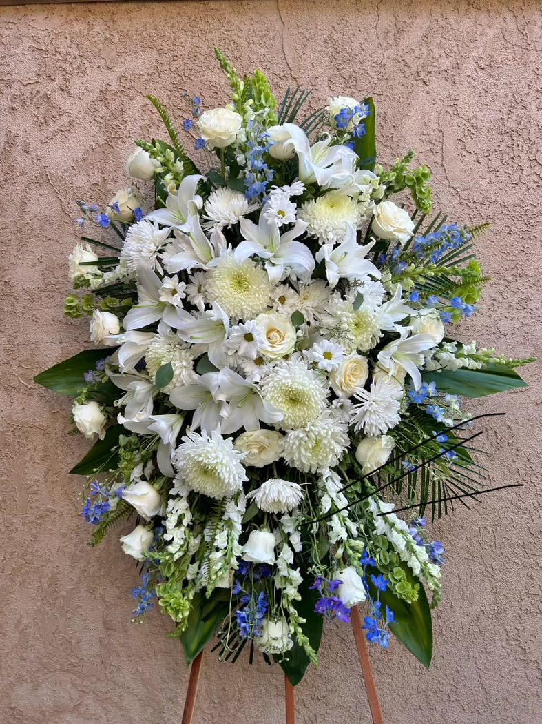 Oceanic  - Beautiful blue and white spray arrangement featuring lilies, chrysanthemums, delphinum, and green accents