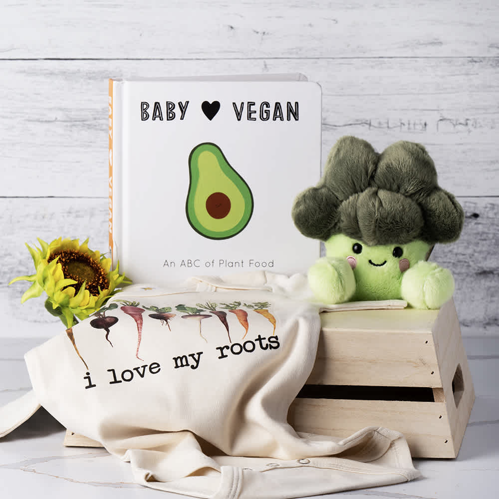 Little Vegan Baby Basket Little Vegan Baby Basket - Celebrate the arrival of a little one with our charming Vegan Broccoli Baby Gift Basket. This delightful collection includes a baby vegan book to inspire and educate, an adorable broccoli plush for endless snuggles, and a cute "I Love My Roots" baby onesie to keep the little one looking stylish. Thoughtfully curated to bring joy and warmth, this gift basket is the perfect way to welcome the newest member of the family while promoting a love for vegan values. Contents: Baby Vegan Book, Broccoli Plush, "I love My Roots" baby onesie