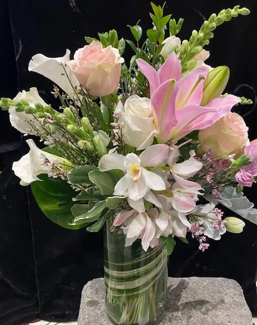Make it Classy Make it Classy - Nothing could be classier than a sparkling clear 10" glass vase, lined with aspidistra leaves, and filled with the best qulity fresh flowers available. Pink Oriental lilies fluffy pink roses, white mini Cymbidium orchids, snapdragon and lisianthus. This will send a messsage to the recipient that they are worth only the very best to you!