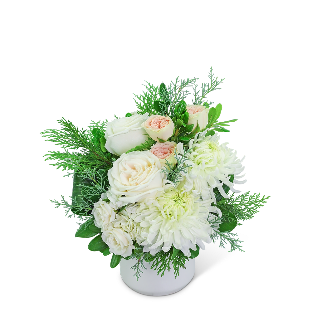 Frosted Fairytale - Our stunning cream and blush flowers are long-lasting and the perfect gift for any occasion. Traditional roses, contemporary mums, and playful hydrangea mix to create a stunning bouquet! Frosted Fairytale is bursting with blossoms and arranged in an eye-catching white vase, accented with premium winter foliage. A shop favorite, this timeless beauty is perfect for any occasion!
