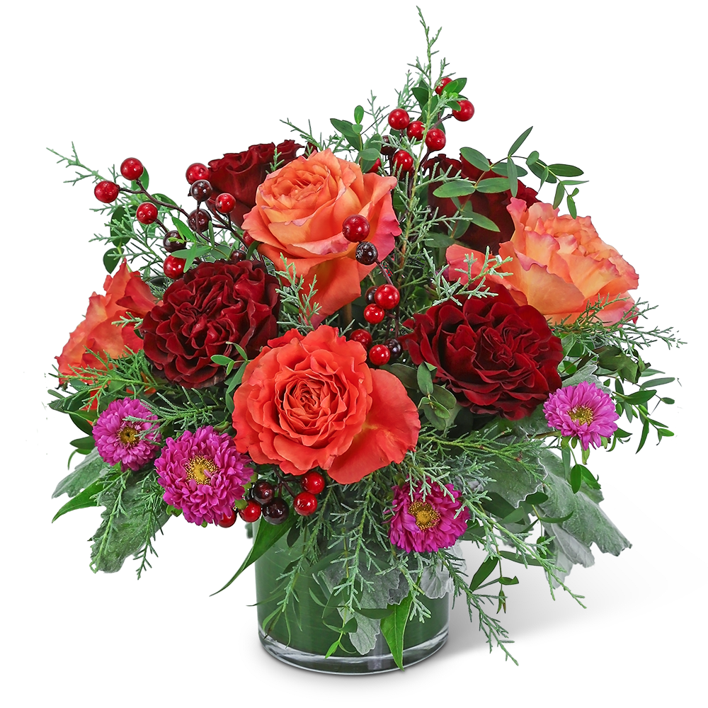 Midnight Winter Spirit - The vibrant colors in this arrangement are sure to brighten up any space. Midnight Winter Spirit features premium roses, Matsumoto Asters, and the perfect touch of winter foliage. This non-traditional winter flower design is the perfect holiday flower arrangement for a gift or just to add fresh flowers to your holiday home decor. We specialize in local flower delivery and take pride in our unique flower designs and excellent customer service.