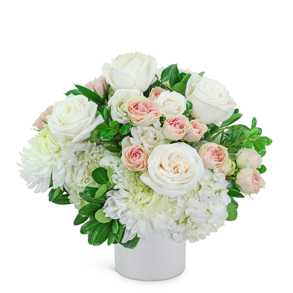 Vogue at Home - Our stunning cream and blush flowers are long-lasting and the perfect gift for any occasion. Traditional roses, contemporary mums, and playful hydrangea mix to create a stunning bouquet! Vogue at Home is bursting with blossoms and arranged in an eye-catching white vase, accented with premium foliage. A shop favorite, this timeless beauty is perfect for any occasion!