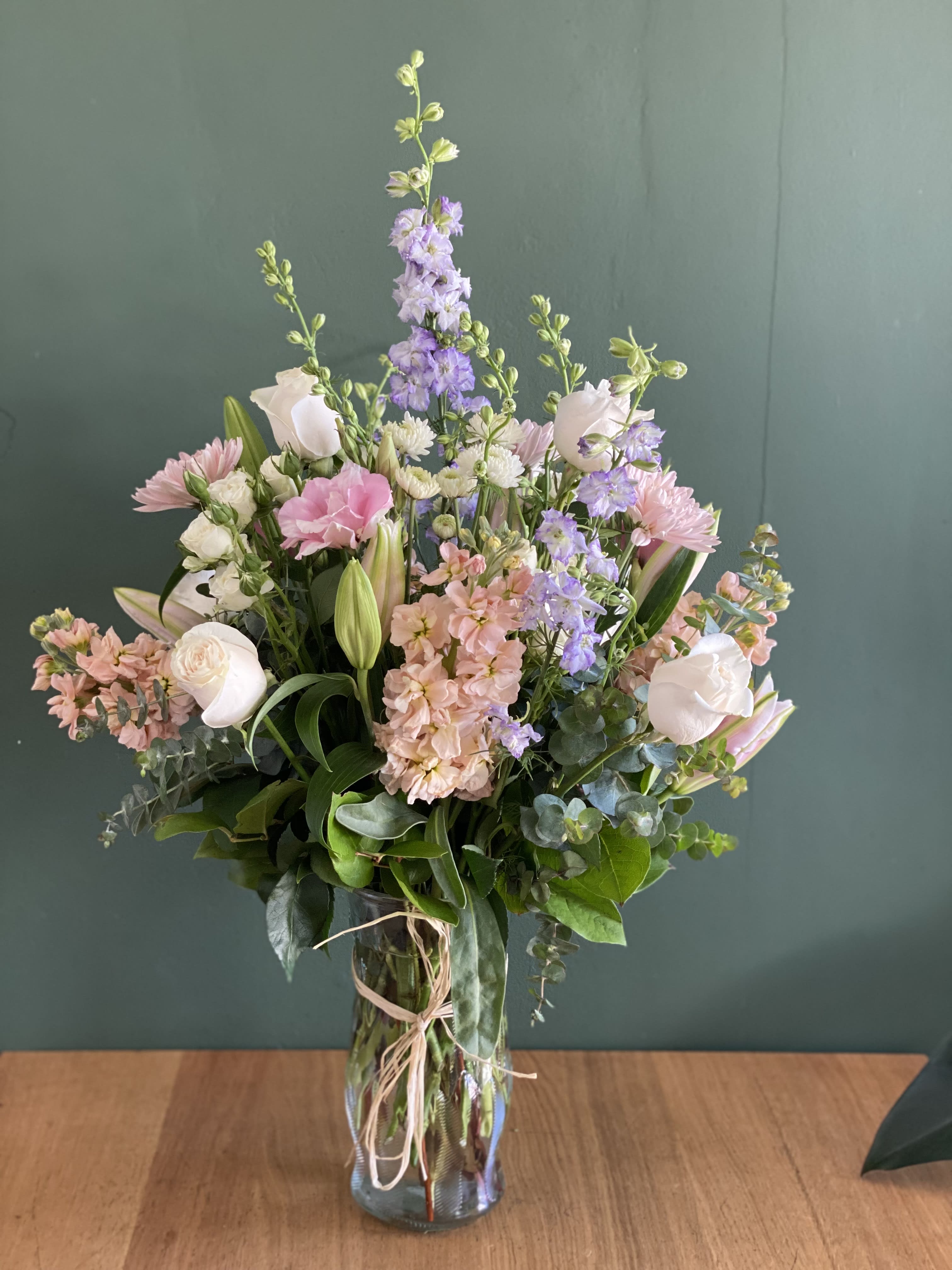 Ocean dream - A soft tone, seasonal design of mixed summer blooms, arranged in a tall glass vase.