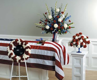 The Patriot - For red and white patriotic funeral arrangements, you can collaborate with local florists or funeral service providers who specialize in creating tributes with a patriotic theme. Consider arrangements such as casket sprays, standing sprays, wreaths, or floral displays that incorporate red and white flowers, symbolizing the colors of the national flag. Common choices might include red roses, carnations, or gerbera daisies paired with white lilies or chrysanthemums. To enhance the patriotic theme, you may also include blue flowers or ribbon accents. Discussing your preferences, the deceased's background, and any specific symbols or emblems associated with patriotism will help in creating a meaningful and respectful floral tribute for your loved one's funeral service.