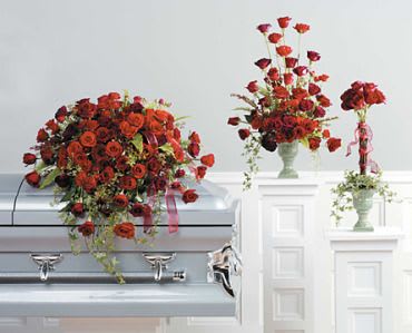 The Red Rose Sympathy Collection - The Red Rose Sympathy Collection is a timeless and elegant series of floral arrangements designed to convey deep condolences and love during times of grief. Red roses, with their symbolic representation of love and respect, take center stage in these arrangements, creating a poignant and heartfelt tribute. The collection may include various arrangements such as casket sprays, standing sprays, wreaths, or bouquets, all adorned with lush greenery to enhance the classic beauty of the red roses. The rich and vibrant hue of the roses serves as a powerful expression of enduring love and serves to honor the memory of the departed. This collection is crafted to offer solace and comfort to those mourning the loss of a loved one while celebrating the everlasting impact of their presence. 