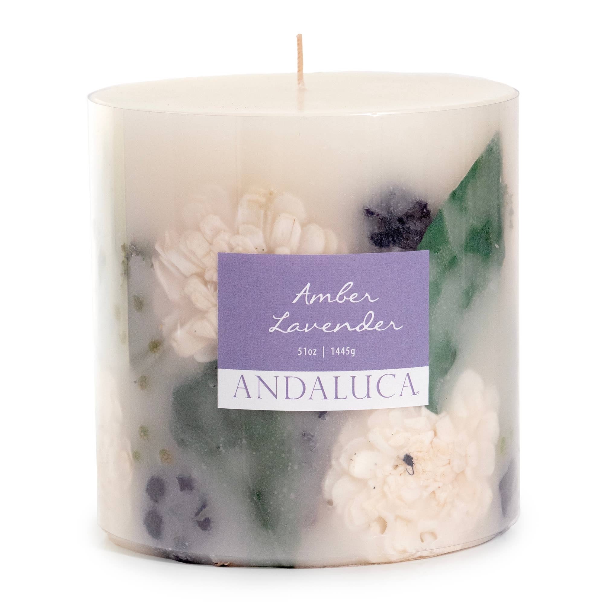 Amber Lavender Botanical Pillar Candle - Gift this beautiful, large candle that will light up and fill any room with sensual fragrance. Each candle is unique and made with dried flowers captured within its wax.   Andaluca’s team is a collaboration of fragrance experts, botanical stylists and artisans all driven by a shared passion to create the best home fragrance products in the world. Andaluca’s collection of botanical hand poured pillar candles are a beautiful addition. They are a marvelous blend of potpourri and candle, creating a stunning botanical glow as the pillar burns down and diffuses Andaluca’s trademark signature scents.  Fragrance notes: Top: cool calone, crushed lavender leaves, aquatic notes. Middle: white eucalyptus, wild lavender, rose. Base: crystal amber, sheer musk, teakwood.  Dimensions: 5” x 5”  burn time: 100 hours  51 oz.