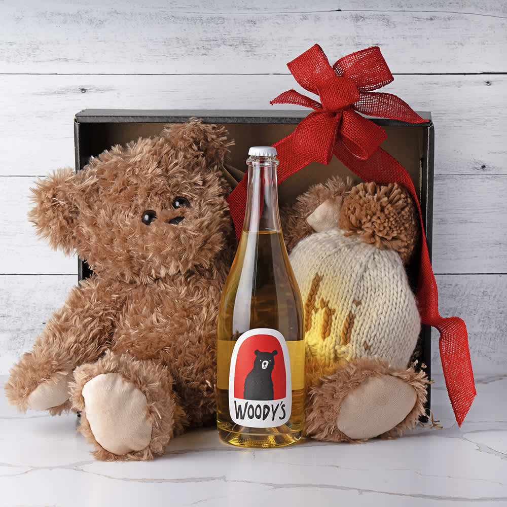 Bear Hugs, Snuggles and Sparkles Baby Gift Bear Hugs, Snuggles and Sparkles Baby Gift - Welcome the newest bundle of joy with our delightful Beary Baby Gift Basket. This charming collection includes a cuddly plush bear, perfect for snuggles and comfort, a cozy baby beanie to keep the little one warm and stylish, and a bottle of non-alcoholic sparkling cider for mom to celebrate this special moment. Thoughtfully curated to bring joy and warmth to both baby and mom, this gift basket is the perfect way to share in the excitement of a new arrival. Contents:12" Classic Brown Bear Plush, "Hi" Baby Beanie Hat, Woody's Non-Alcoholic Blanc de Blanc