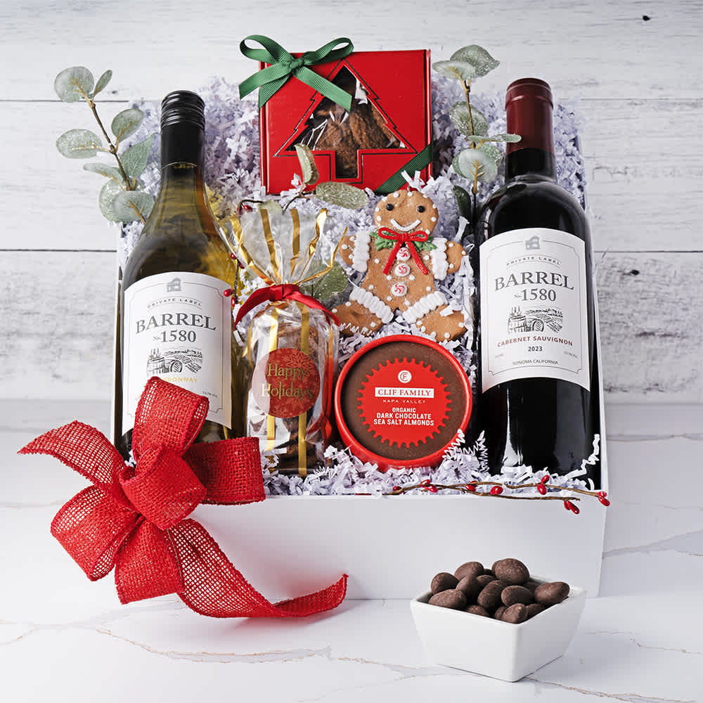 Holiday Wine and Sweet Treats Gift Box Holiday Wine and Sweet Treats Gift Box - Celebrate the season with our Holiday Wine and Sweet Treats Gift Box, a festive collection perfect for spreading holiday cheer. This elegant gift box includes two exquisite wines: Barrel 1580 Chardonnay and Barrel 1580 Cabernet Sauvignon, each offering rich and delightful flavors. Accompanying the wines are charming Christmas Tree Box Cookies and Happy Holidays Chocolate, adding a sweet touch to your celebrations. A delightful Gingerbread Man Ornament brings a whimsical holiday spirit, while Dark Chocolate Sea Salt Almonds offer a perfect blend of sweet and savory. Accented with Eucalyptus Springs for a refreshing aromatic touch, this thoughtfully curated gift box is the perfect way to share joy and warmth this holiday season. Contents: Barrel 1580 Chardonnay, Barrel 1580 Cabernet Sauvignon, Christmas Tree Box Cookies, Happy Holidays Chocolate, Gingerbread Man Ornament, Dark Chocolate Sea Salt Almonds, Euclyptus Springs