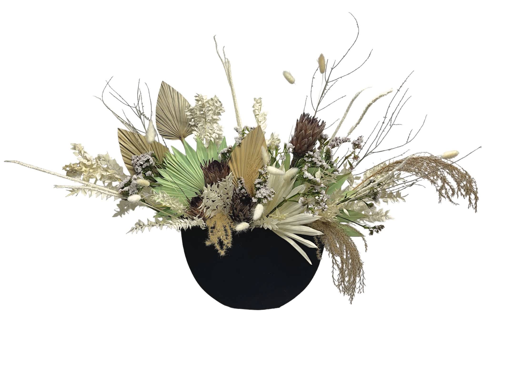 Forever Beautiful Dried Arrangement  - This arrangement is made with 100% preserved flowers. Included in this arrangement are fan palms of white and mint green colors, Italian ruscus, bunny tail grass, dried proteas, and statice. This arrangement, in an elegant slim black container, is perfect for a display in a modern house hold or office building as they will not wilt. You could also consider this as a nice idea to send as a condolence, as they will not need to care for or discard the flowers after the flowers are past their prime!