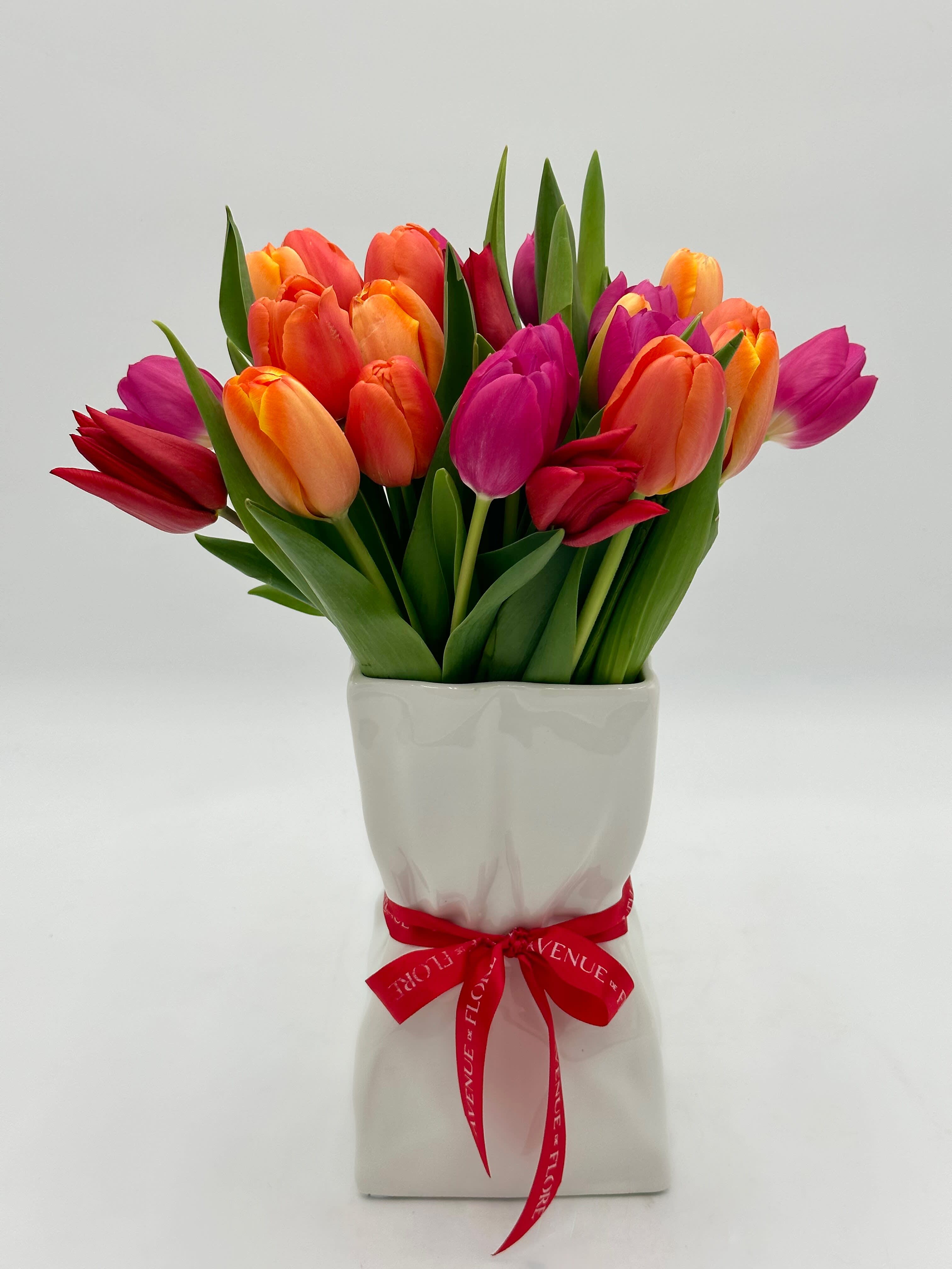 Tulip Chic - This unique arrangement harmoniously blends the natural beauty of tulips captured within the contemporary elegance of a paper bag ceramic vase. A delightful addition to your home decor that promises to bring warmth, style, and a breath of fresh air to every room. 