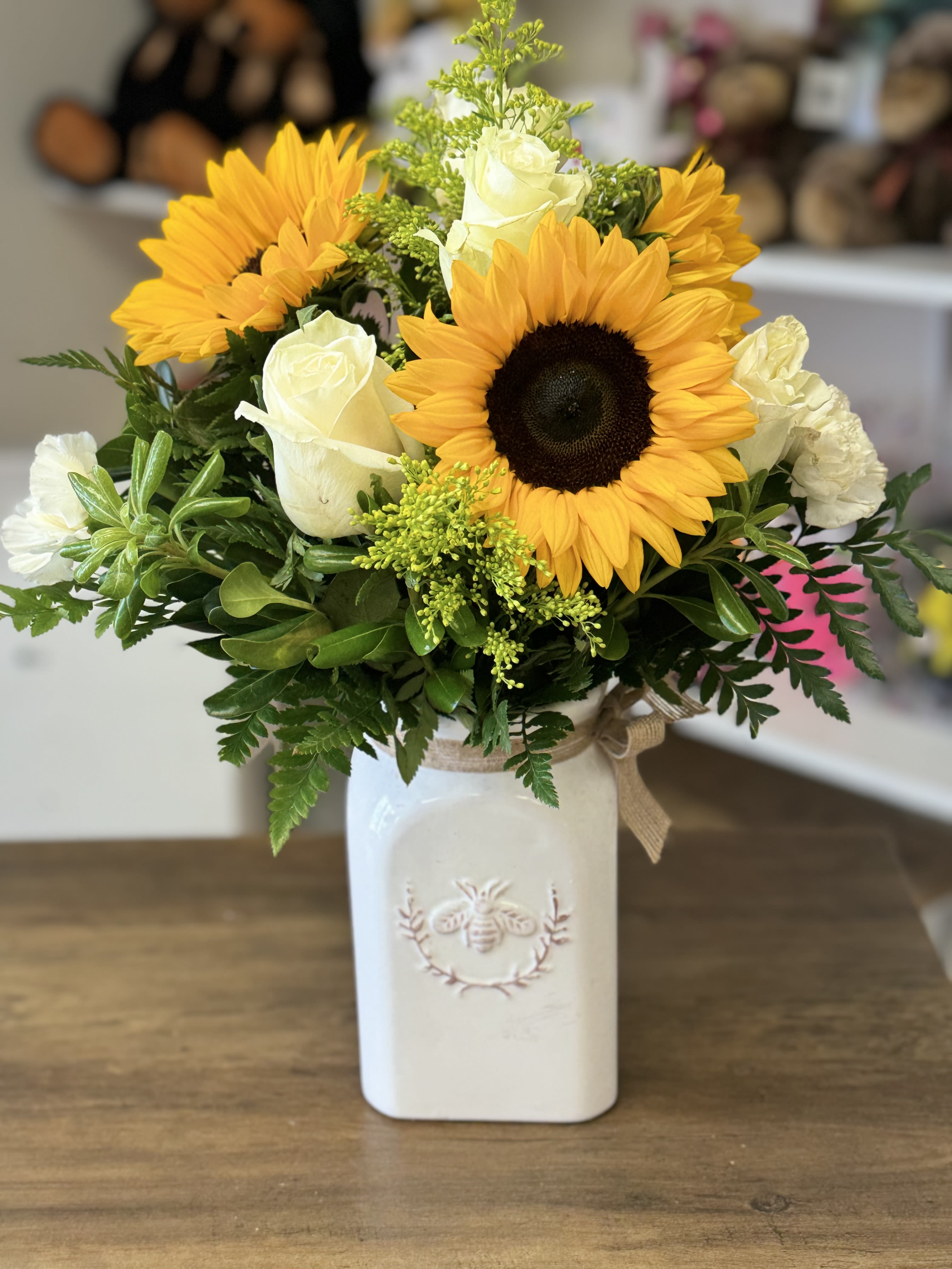 Bee Around Me - Sunflowers mixed with different color stems arranged in a  keepsake vase. 