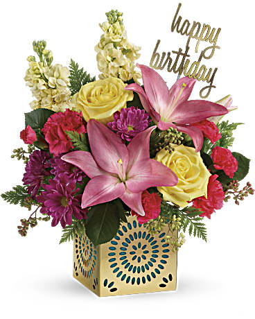 Teleflora's Blooming Birthday Bouquet - Make it a blooming unforgettable birthday with this gorgeous bouquet of soft yellow roses and pretty pink lilies! Complete with a Happy Birthday pick, the blooms are arranged in a gleaming golden cube with delicate punched details! The beautiful blooms in this bouquet include light yellow roses, pink asiatic lilies, hot pink carnations, hot pink miniature carnations, light yellow stock, and purple daisy spray chrysanthemums accented with leatherleaf fern. Delivered in a Celebrate in Style Cube.