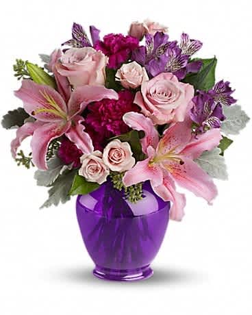 Teleflora's Elegant Beauty - Take their breath away with a spectacular array of pink roses and lilies in a classic ginger jar in deep royal purple. Truly a stunning gift, but without a stunning price tag. The opulent bouquet includes pink roses, light pink spray roses, light pink oriental lilies, purple alstroemeria and fuchsia carnations accented with assorted greenery. Delivered in a deep purple ginger jar.