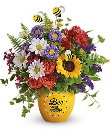 Teleflora's Garden Of Wellness Bouquet - Boost their spirits and brighten their day with this garden of wellness! Hand-delivered in a sweet ceramic &quot;Bee Well Soon&quot; pot, this colorful arrangement of roses, alstroemeria and asters is abuzz with delightful bee decorations - and your very best wishes for a speedy recovery. Includes orange spray roses, red alstroemeria, lavender matsumoto asters, yellow sunflowers, green button mums, white daisies, purple statice, pink sweet william, bupleurum, sword fern, leatherleaf fern, variegated pittosporum and ivy. Delivered in a Buzzing Bee Well pot.