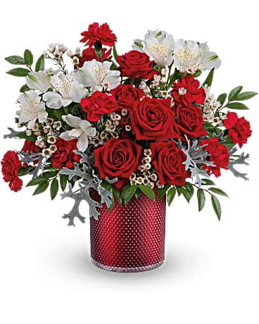 Teleflora's Heart Of Diamonds Bouquet Teleflora's Heart Of Diamonds Bouquet - This radiant red rose bouquet is presented in a shimmering scarlet glass vase with elegant embossed diamond pattern. Send red spray roses, white alstroemeria, miniature red carnations and white waxflower accented with silver lace dusty miller and huckleberry. Delivered in a Scarlet Diamond Cylinder.