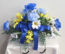 Always Remembered Tombstone Hugger Always Remembered Tombstone Hugger - A fitting tribute to your love ones. This Silk floral saddle spray attaches to the top of a above ground gravestone. Firmly attaching with movable wire arms. (Caution: May not hold up in strong winds) Can be created in a variety of color choices. Allow extra time for custom work. (NOT available for Same Day Delivery)