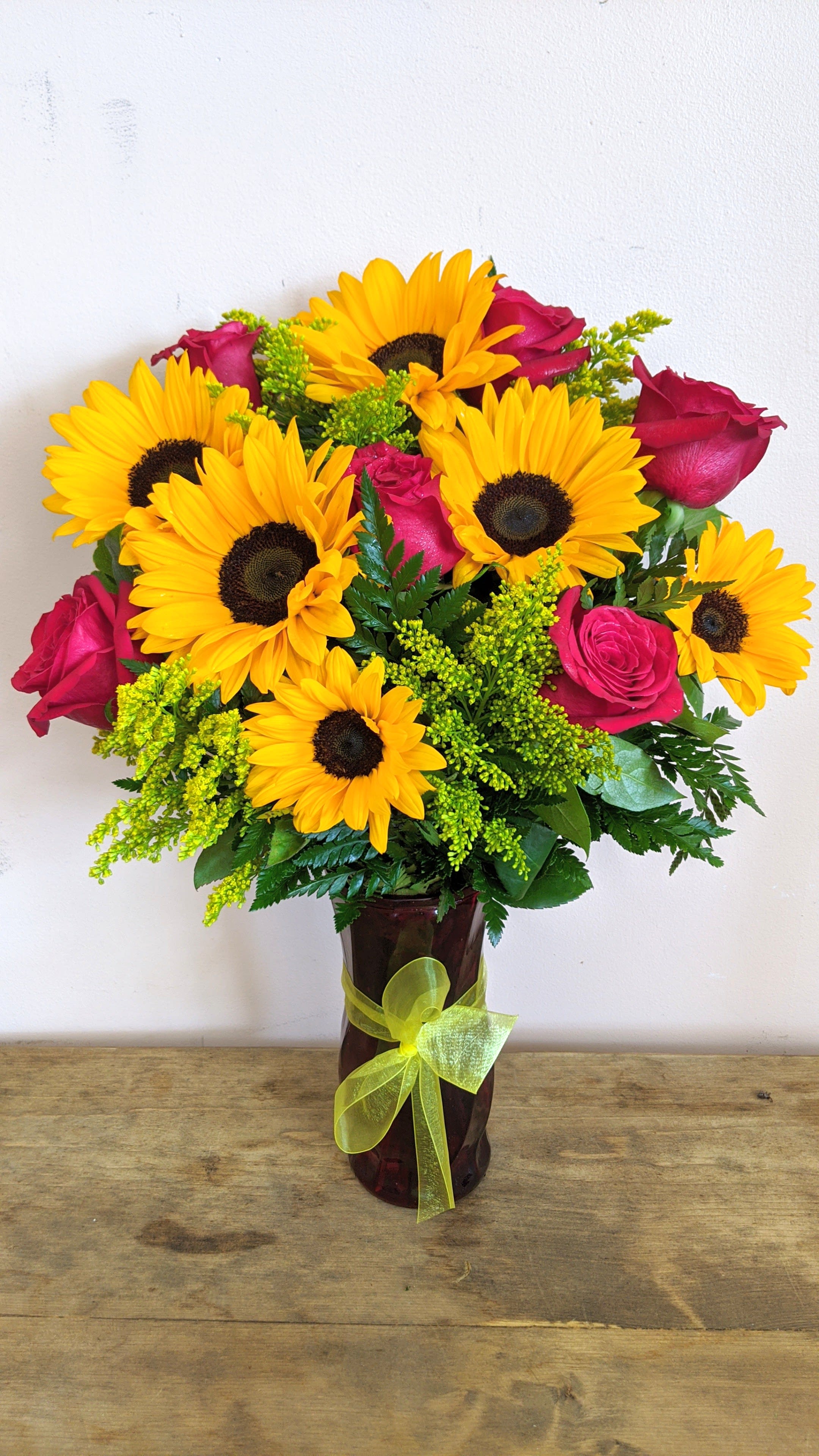 Red Rose And Sunflower Bouquet - The standard bouquet will have 6 roses and 6 sunflowers in a red vase with a yellow filler for a stunning vibrant look. upgrades will have extra roses.