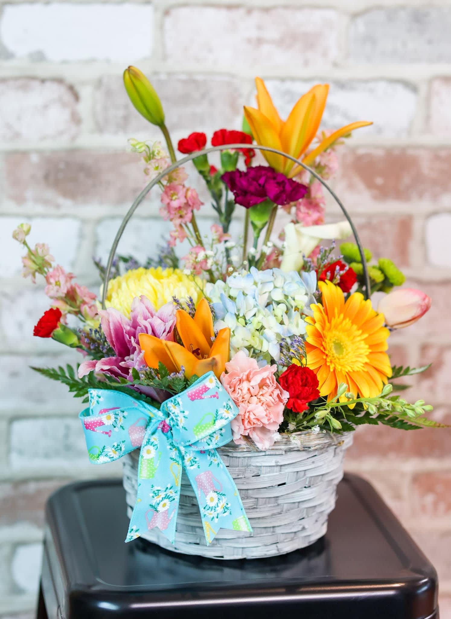 Basket of Love Basket of Love - Surprise your special loved one with this basket of love. With a whitewashed basket of lilies, gerbera daisies, a blue hydrangea, tulips and carnations.
