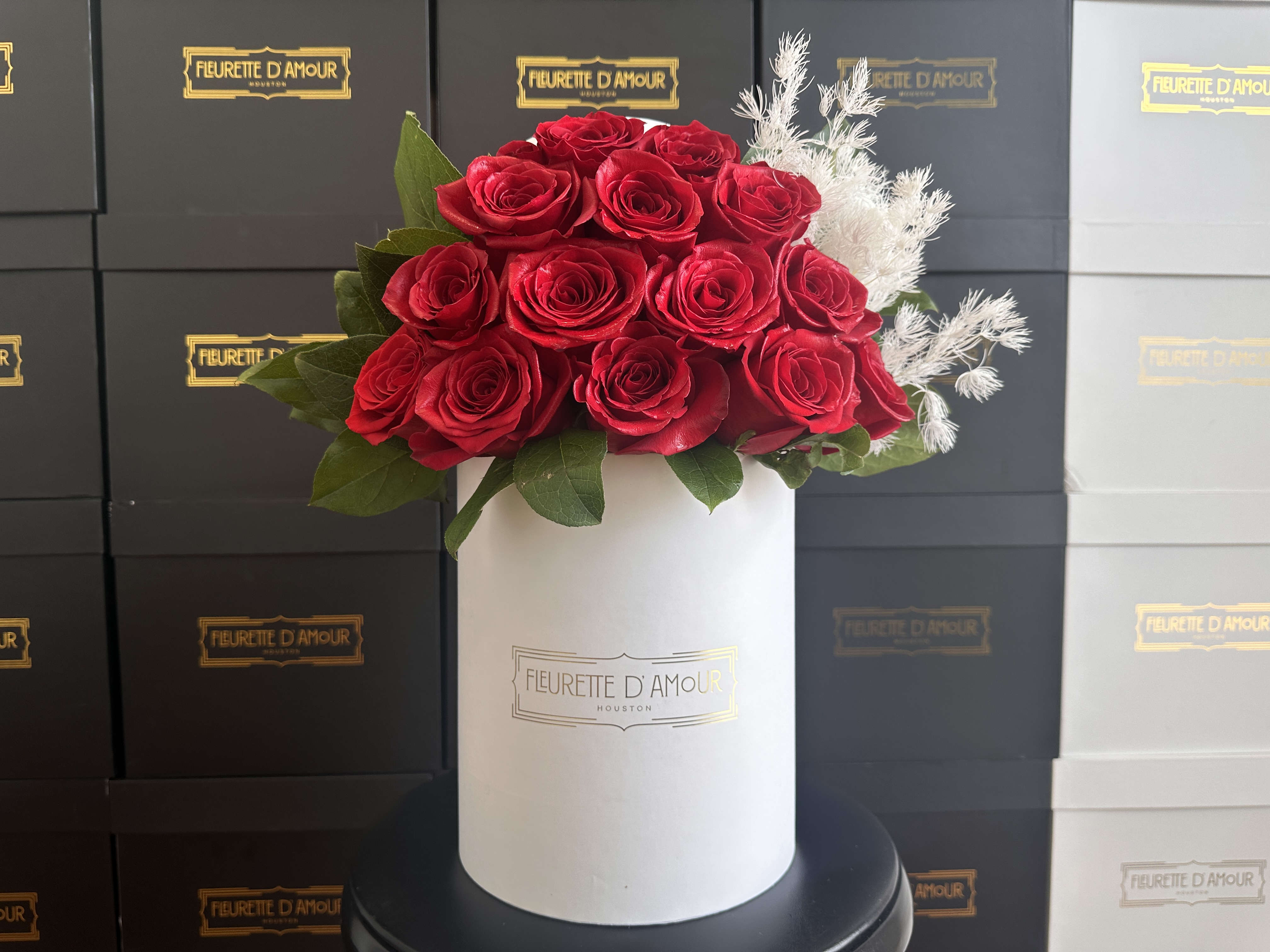 Jolie - Introducing our &quot;Jolie Box,&quot; a stunning medium-sized box that embodies elegance at its finest. Open it to reveal the enchanting sight of 15 fresh roses, meticulously arranged to form a breathtaking floral masterpiece. The delicate beauty of the blooms contrasts beautifully against the sophisticated backdrop of the box, enhancing its visual appeal and making it the perfect gift for any occasion. Elevate your gifting experience with the timeless allure of roses expertly arranged in our Jolie Box. Order now to add a touch of grace and sophistication to your celebrations.  PLEASE NOTE THAT WE CURRENTLY ONLY HAVE BLACK BOXES AVAILABLE IN THIS SIZE.