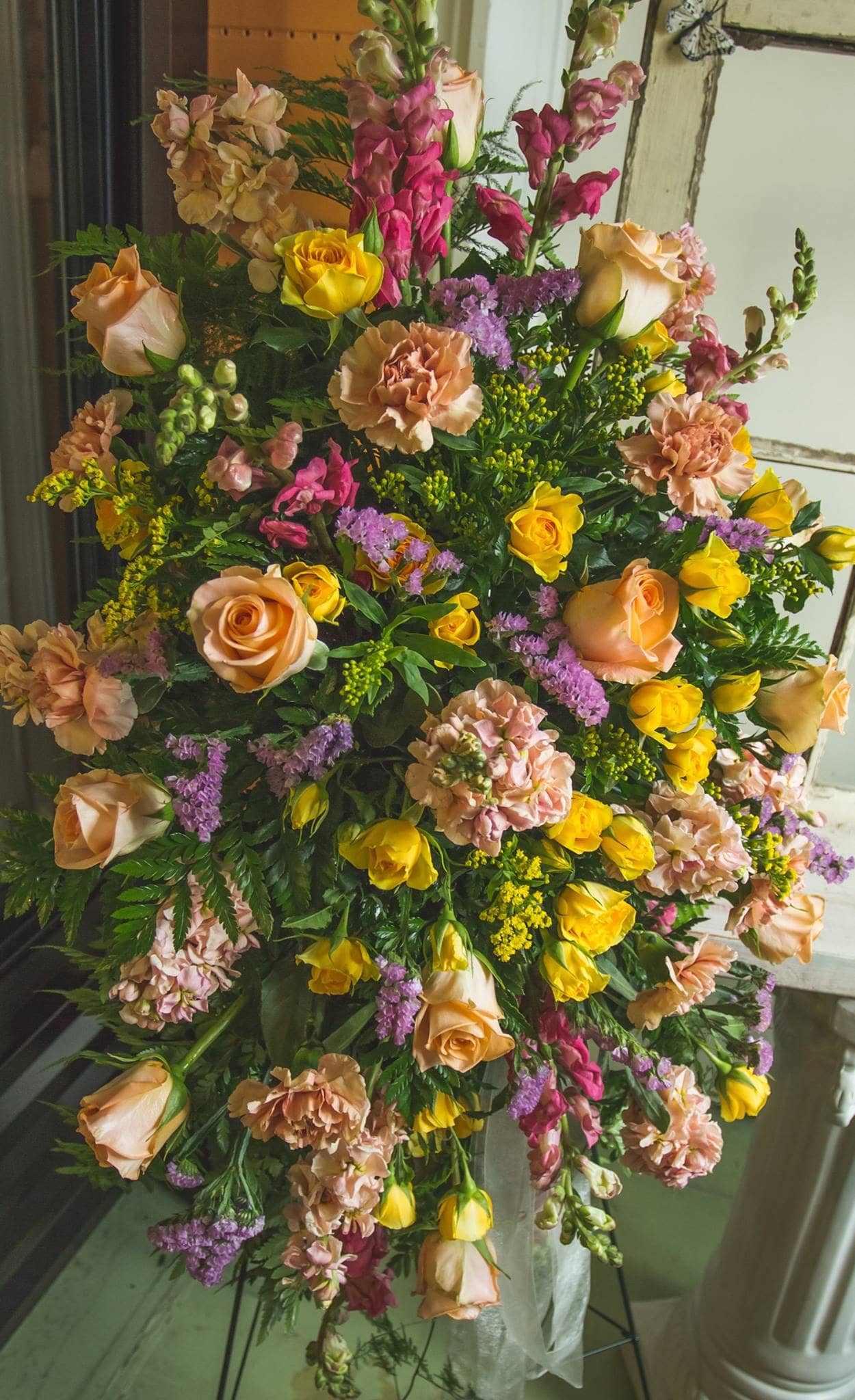 Adelaide  - Standing spray of Roses, Spray Roses, Carnations, Stock, and various filler. 