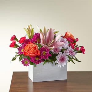 Light of my Life in a box Light of my Life in a box - From life's big moments to sweet just because sentiments, the Light of My Life Box Bouquet is designed to celebrate your loved ones any day of the year. RSVP'd to the party are hot pink carnations, orange roses, lavender cushion poms and lush greens. Please Note: The bouquet pictured reflects our original design for this product. While we always try to follow the color palette, we may replace stems to deliver the freshest bouquet possible, and we may sometimes need to use a different vase. DETAILS The Deluxe Bouquet is approximately 11"H x 13"W. Designed by florists, ready to display. For long–lasting blooms, add water daily. Pet Safety Precautions: This bouquet or plant may include flowers and foliage that are known to be toxic to pets. To keep them safe, be sure to keep this arrangement out of your pet's reach. BLOOM DETAILS Carnation Lily Rose Daisy