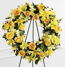 Ring Of Friendship Ring Of Friendship - This beautiful all yellow standing spray consists of yellow Lilies, Yellow Roses, and a few yellow Orchid blooms, with beautiful greens. The perfect way to say "until we meet again".