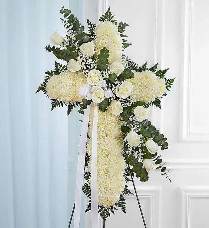White cross - Celebrate a life of faith and devotion with our elegant sympathy arrangement. A bed of pristine white blooms is crafted into the shape of a cross by our caring florists. Flourishes of white flowers cascade down the center. What a beautiful tribute to honor a loved one, while providing peace and comfort when it’s most needed.