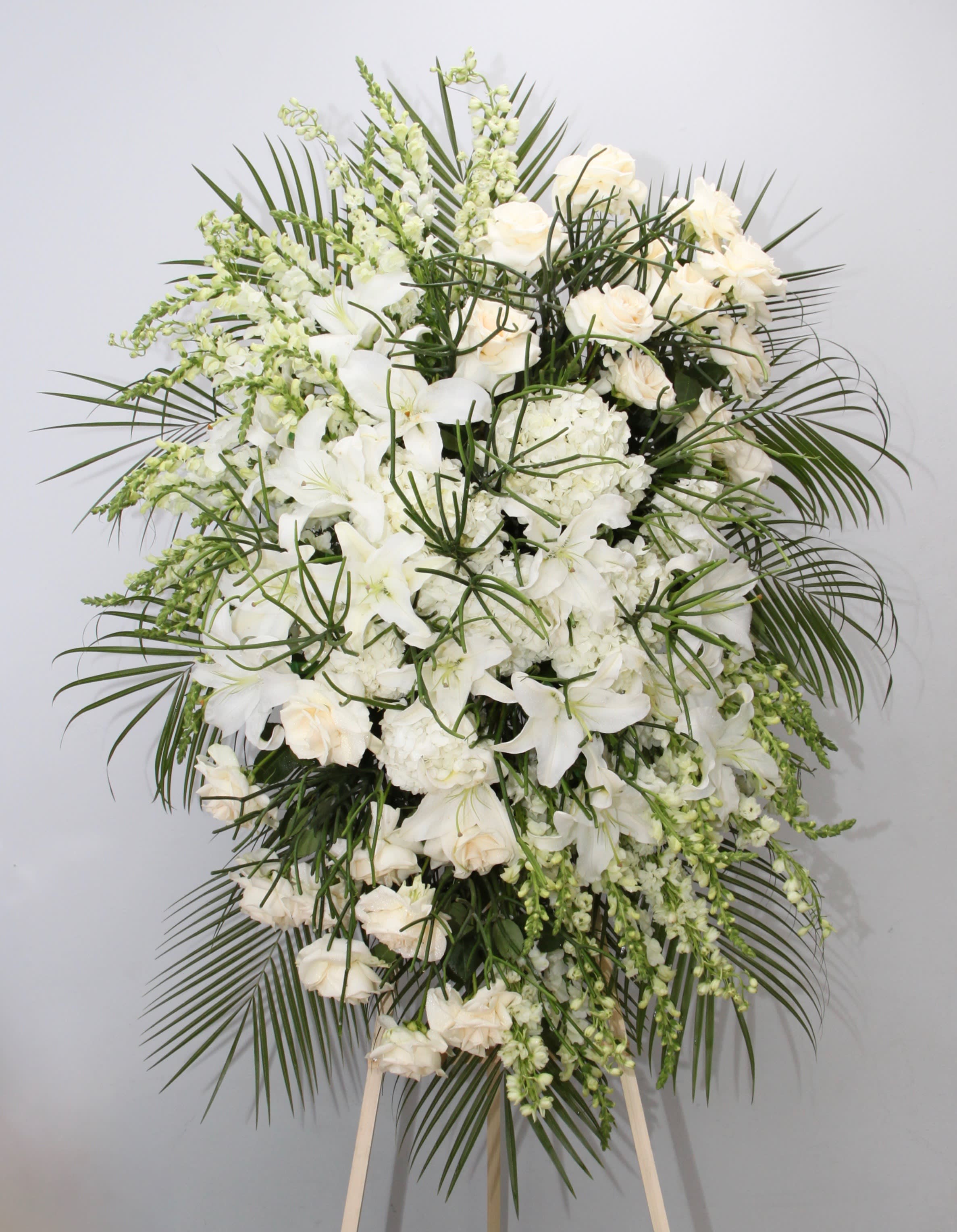 White Spray  - This spray is all white with a touch of seasonal greens.    We include easel, printed banner and delivery (some fees may apply). An additional banner can be added for $15.    Standard size is 30'' wide, deluxe is 36'', and premium is 42''.