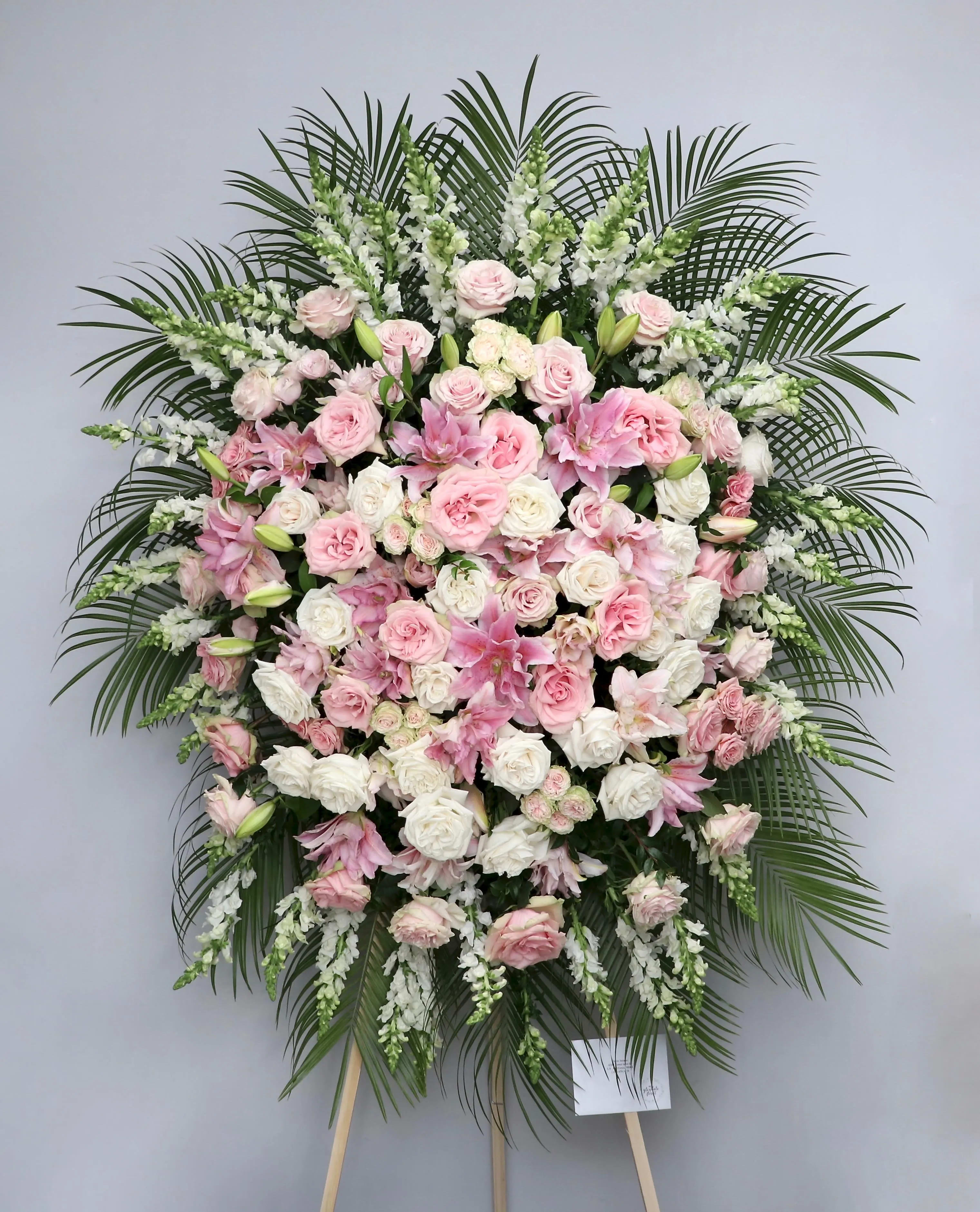 Bright Pink Spray  - With various shades of pink, this arrangement includes roses, stargazer lilies, and seasonal greens.    We include easel, printed banner and delivery (some fees may apply). An additional banner can be added for $15.    Standard size is 30'' wide, deluxe is 36'', and premium is 42''.