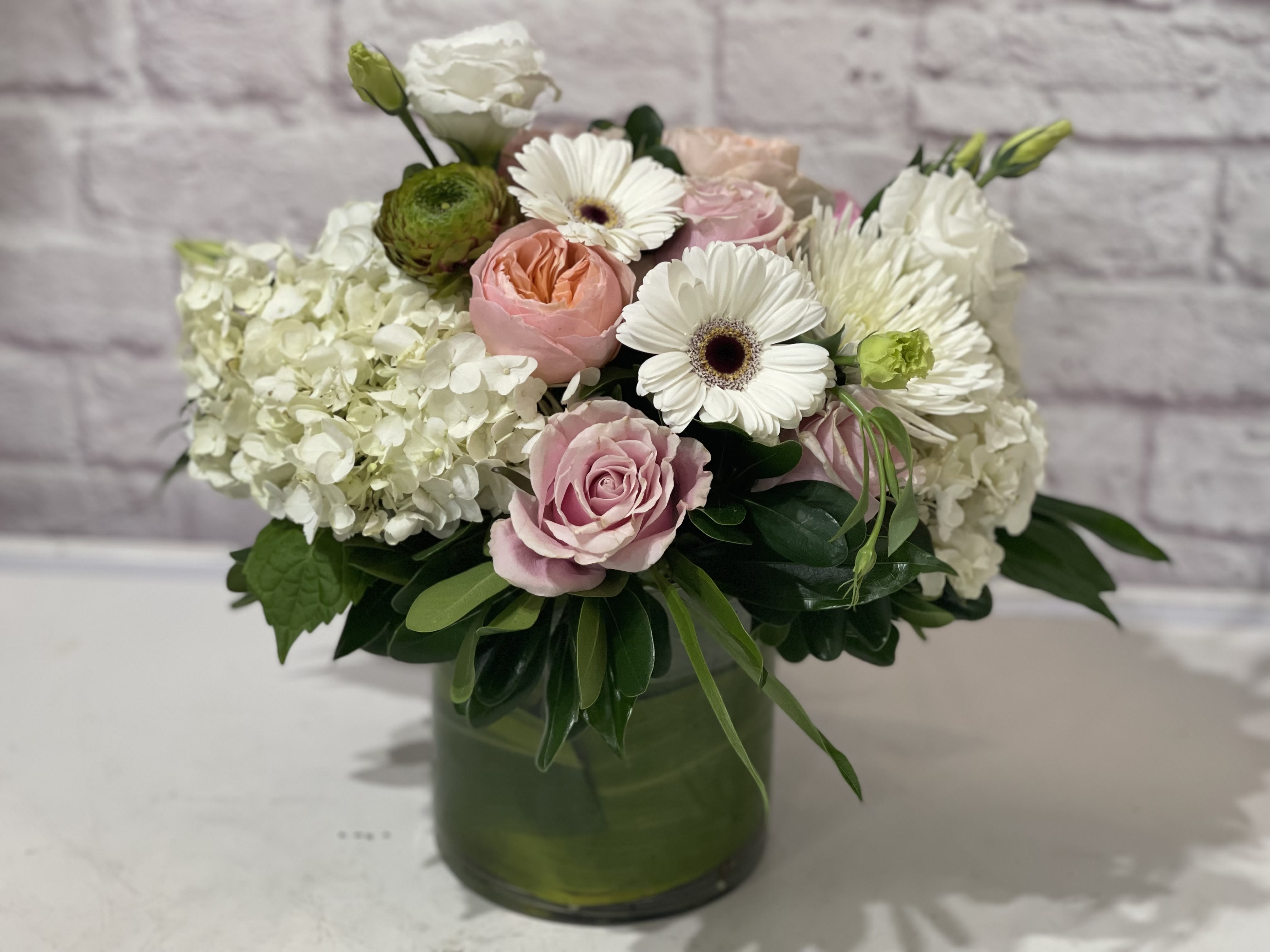 You Are Everything You Are Everything - Pink and white blooms in a white ceramic collectors pot.