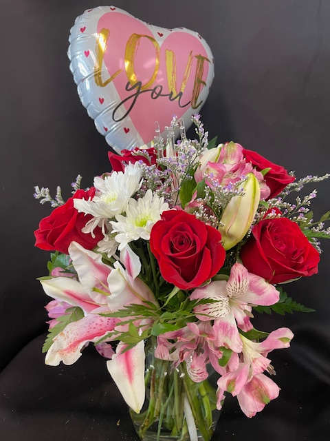 You're So Special! You're So Special! - She is VERY special and show her with this beautiful & elegant arrangment. In a glass vase, an array of lilies, roses,alstoromeria, daisies, and seasonal greenery. Add a stick balloon to complete your sentiment.