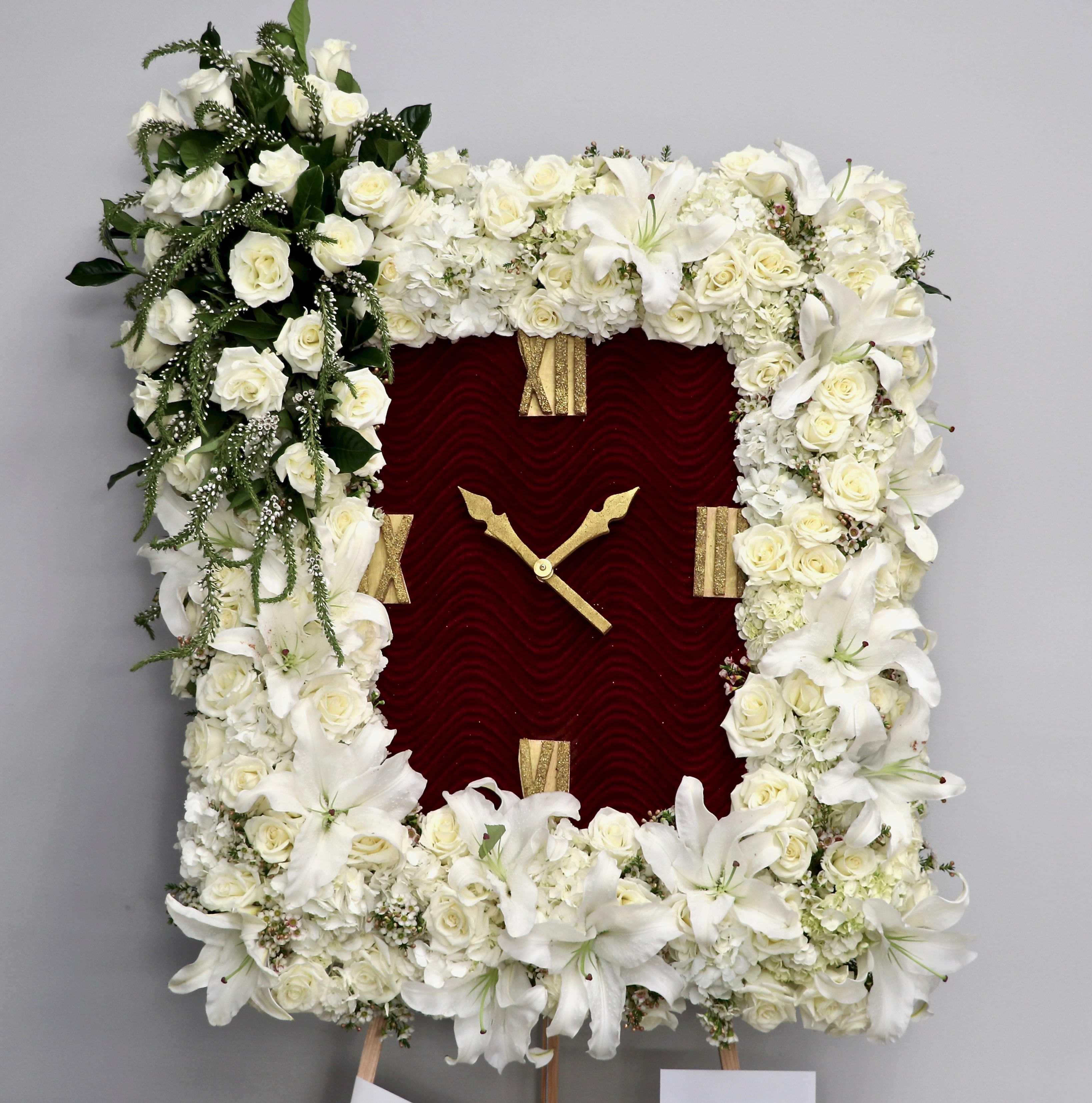 Rose and Lily Clock Rose and Lily Clock - This funeral frame includes casa blanca lilies, roses, hydrangeas, and seasonal greenery. The standard size is approximately 36 inches tall and 24 inches wide. Additional flowers will be added for deluxe and premium sizes.