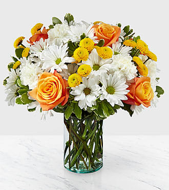 Sweet Moments Bouquet Sweet Moments Bouquet - Through a collection of bold hues, gorgeous flowers, and fresh scents, this bouquet blossoms with beauty in any room that its placed. An array of orange roses, variegated pittosporum, and white daisy pompons come together in a cylindrical glass vase to make the perfect gift for a loved one near or far.
