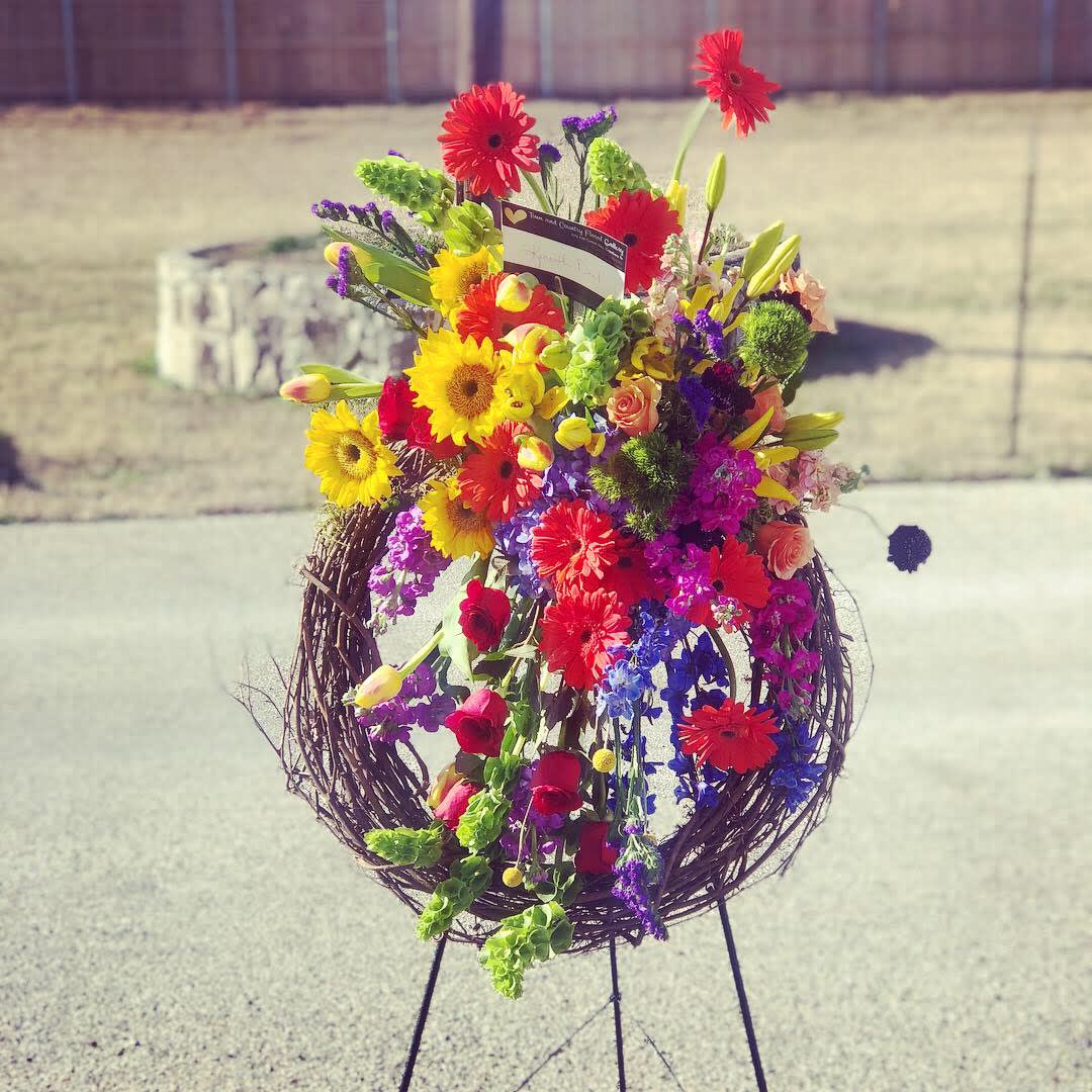 Celebration of Life - Granbury Florist Celebration of Life - Granbury Florist - Wonderful celebration of life easel with a Grapevine Wreath embellished with hydrangea, roses , gerbera, stock etc.