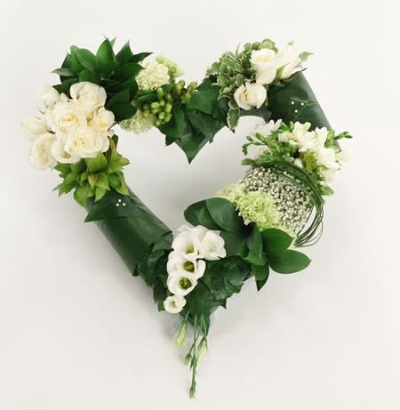 Heartfelt Sympathy in Whites and Greens Heartfelt Sympathy in Whites and Greens - Beautiful heart shaped floral tribute with white roses, white seasonal blossoms and covered in textured greens (florals depend on seasonal availability) on an easel stand * Free delivery to Wiley Funeral Home and Martins Funeral home if placed by phone.
