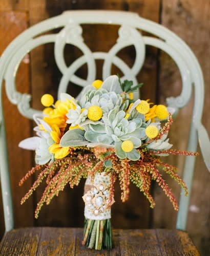 Shades of Grey Shades of Grey - Grey succulents and sunflowers with yellow crespedia balls nestled in and a collar of tinted solidago....stem is embellished with burlap and lace trim.