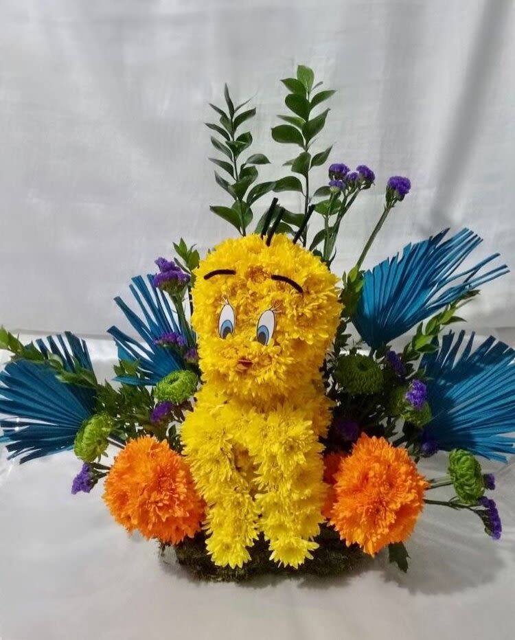 Cheery Yellow Cheery Yellow - This yellow birdy brightens up your day. It is made up of orange and yellow pom poms.