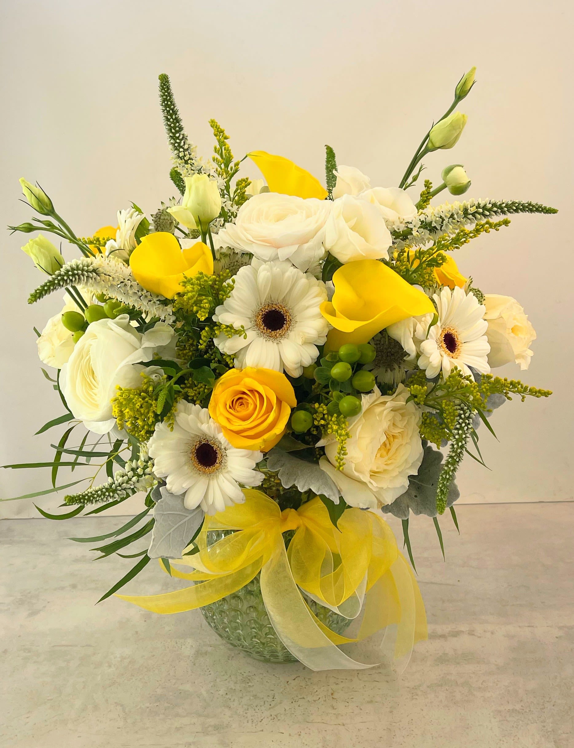 Honey Blossom Bouquet - Sweet as honey, this bouquet is sure to please! Sunny yellow and white blossoms are gathered together in a vase ready to brighten a special someone's day!! Casual yet elegant, perfect for any occasion!