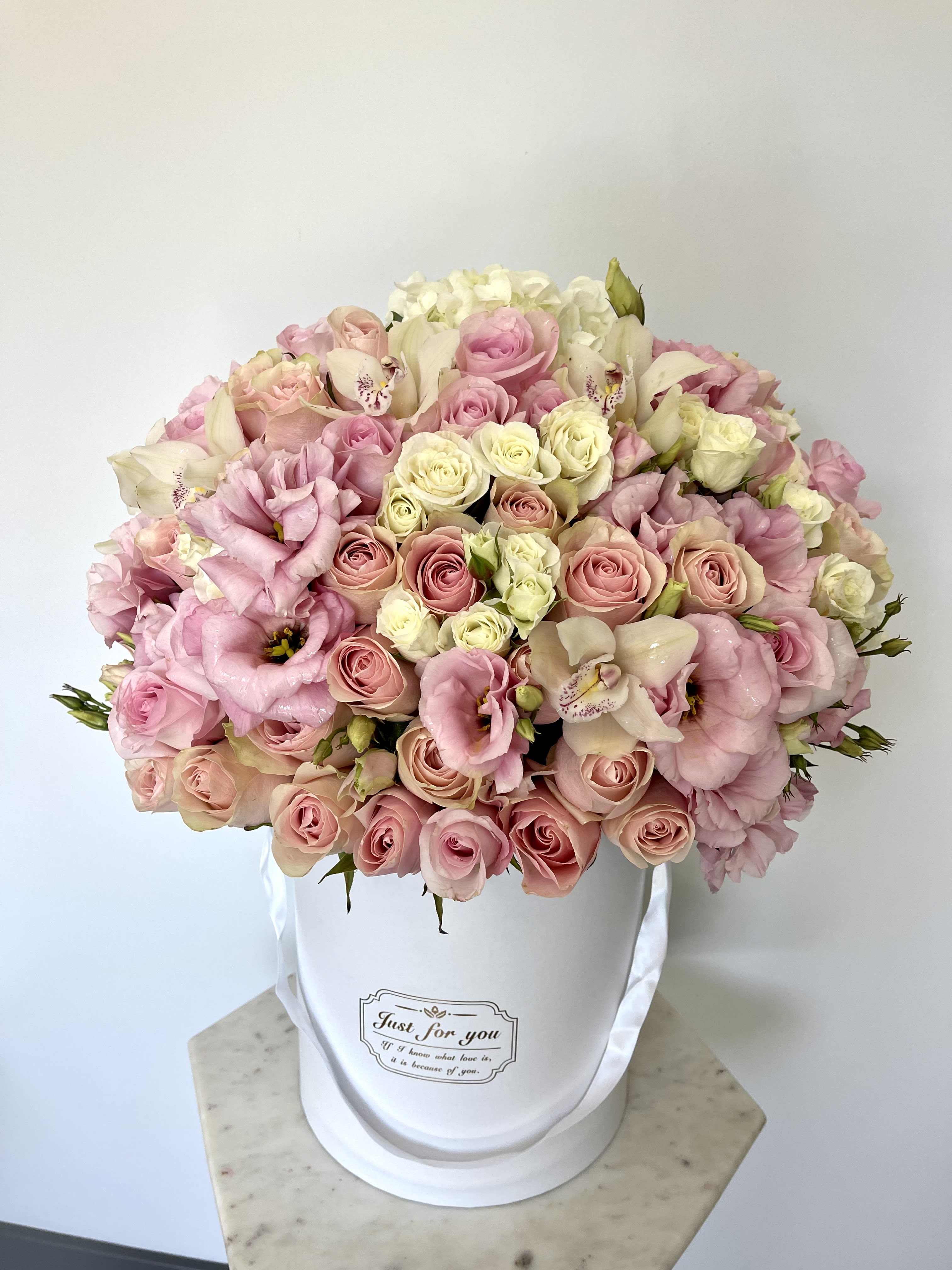 Blossom Wow - This beautiful box contains a combination of fresh roses, hydrangeas and lisianthus  in an ivory box. This floral arrangment is the perfect gift for your loved one!  Arrangement includes: Fresh flowers Medium box measured at 9.75&quot; Dia. x 9.25&quot; H Custom greeting card