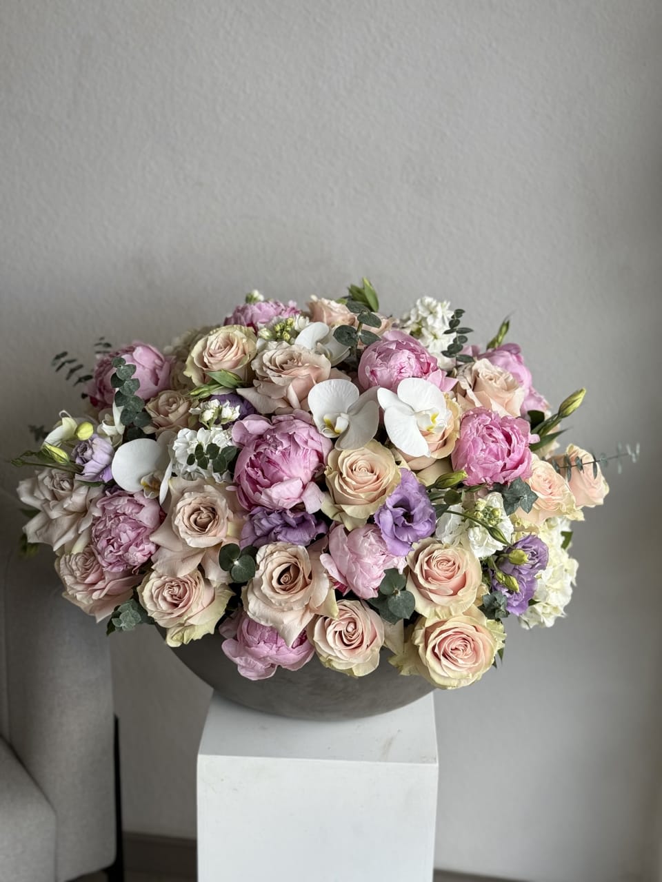 Lively Color Splash - Celebrate life with this explosion of vibrant hues, a lively combination of flowers that brings energy and joy to any setting. A burst of nature's colors in a concrete vase 