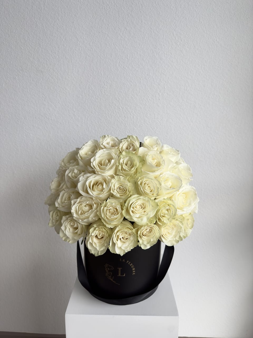 Country Roses Arrangement  - This beautiful arrangement filled with white roses and greens to deliver your special message to your special someone.  Perfect for any occasion. You can choose any color of the box.  Arrangement includes: purple and pink roses SMALL BOX Custom greeting card