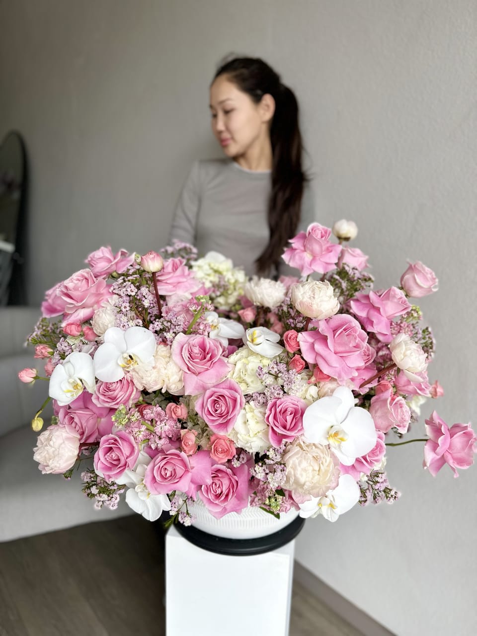 Grand Pink Rose Symphony - An opulent showcase of elegance, the Grand Pink Rose Symphony is a lavish arrangement featuring a cascade of exquisite pink roses. This floral masterpiece captivates with its regal beauty, making it the perfect centerpiece for special occasions. The abundance of blooms creates a visual symphony, transforming any space into a realm of timeless romance and sophistication.