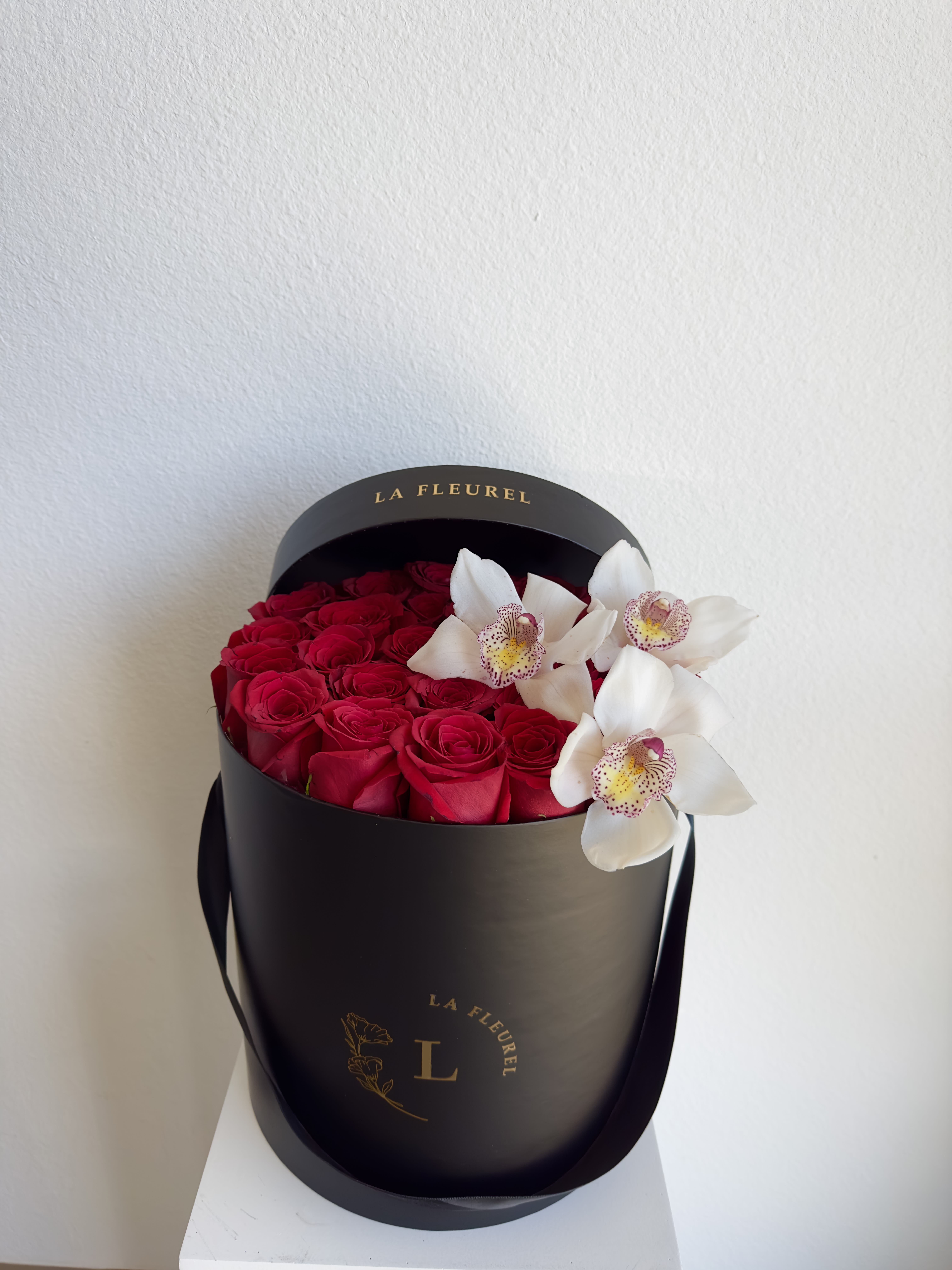 Elegant Roses  - This beautiful arrangement filled with the red roses and orchids to deliver your special message to your special someone.  Perfect for any occasion. You can choose any color of the box.  Arrangement includes: red roses and orchids  Medium box measured at 9.75&quot; Dia. x 9.25&quot; H Custom greeting card