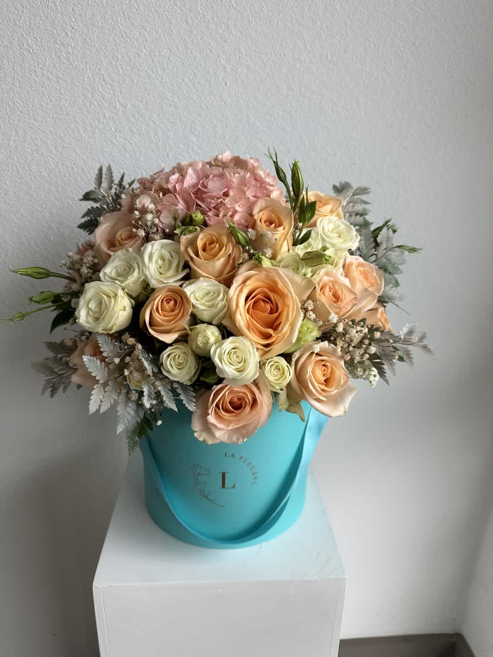 Romantic Tiffany Box - This romantic arrangement includes roses, spray roses and greens.  Perfect for any occasion. You can choose any color of the box.  Arrangement includes:  SMALL BOX Custom greeting card