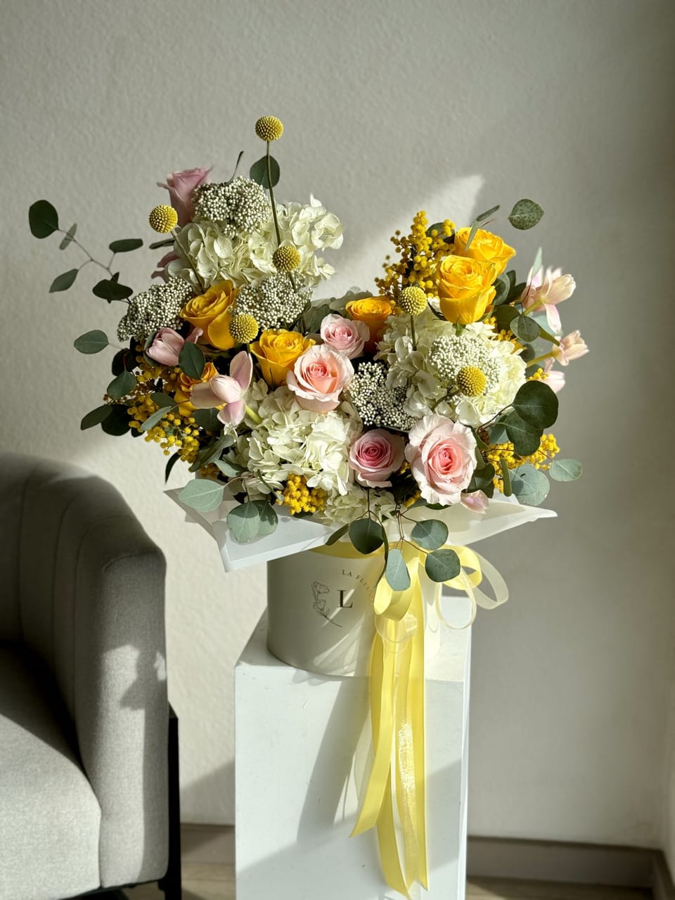 Easter Sunny Arrangement  - The &quot;Easter Sunny Arrangement&quot; bursts with vibrant colors and cheerful blooms, embodying the spirit of the season. Featuring a delightful mix of sun-kissed flowers such as daffodils, tulips, and cheerful yellow roses, this arrangement brings warmth and joy to any Easter celebration. Accented with fresh greens and nestled in a charming vase, it's a perfect centerpiece to brighten your home and spread Easter cheer.