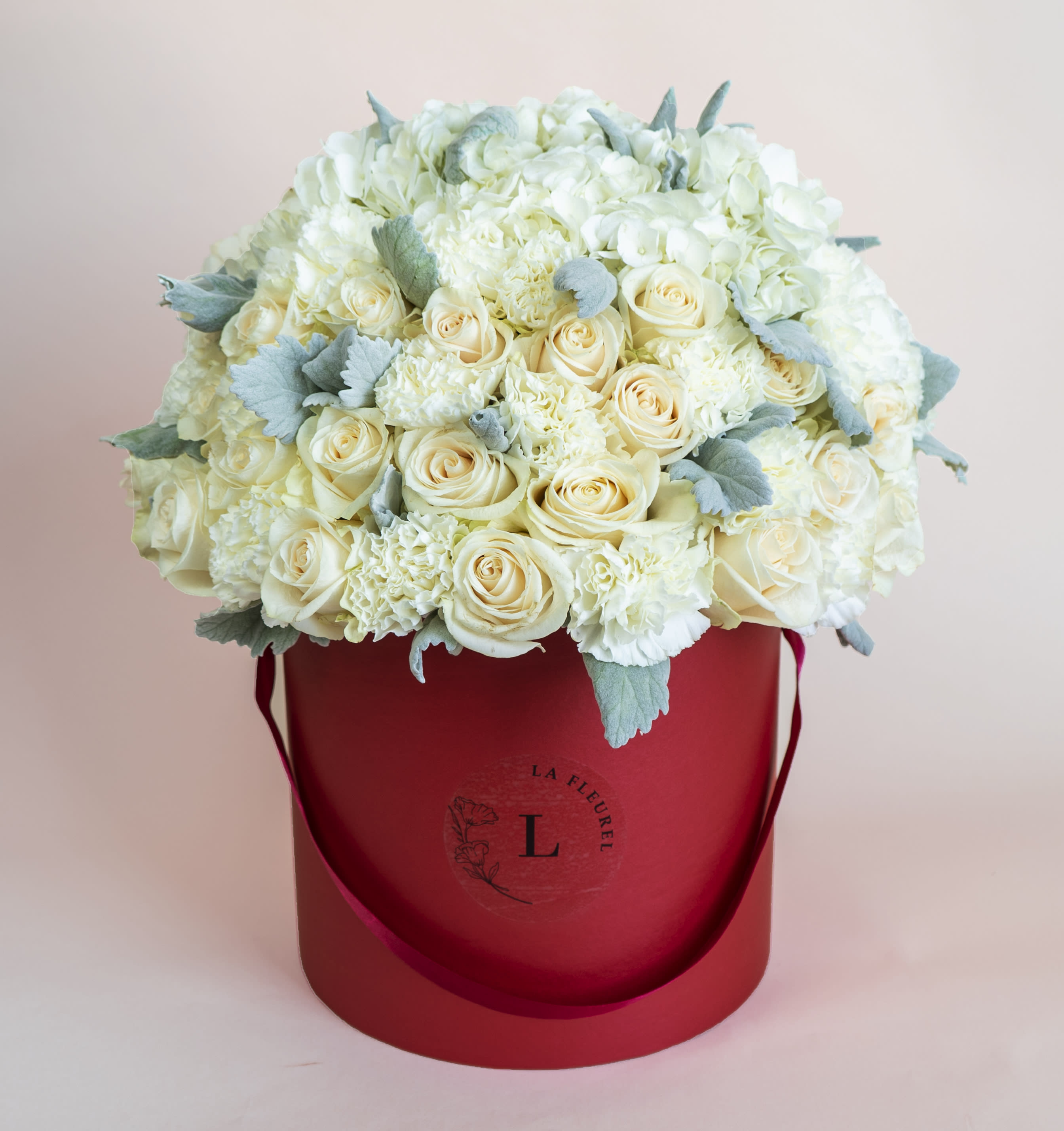 Red Romance - This beautiful arrangement is filled with white roses to deliver your special message to your special someone.  Perfect for any occasion. You can choose any color of the box.   Arrangement includes: white roses, hydrangea, carnations and dusty miller Medium box measured at 9.75&quot; Dia. x 9.25&quot; H Custom greeting card