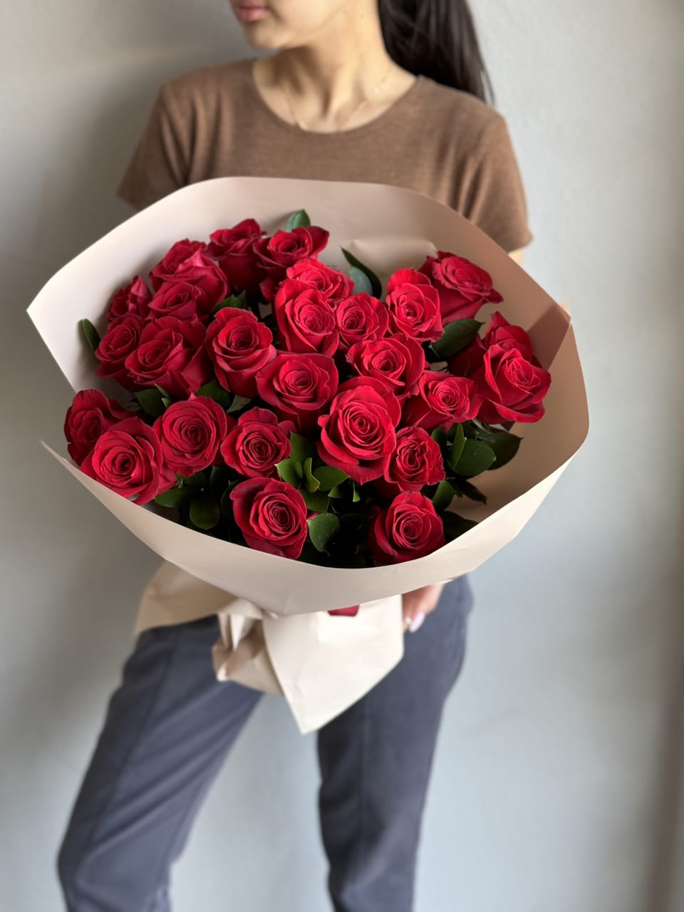 Red Roses Hand held Bouquet  - Indulge in the timeless allure of our Red Roses Bouquet, boasting 25 radiant roses. Each velvety petal whispers of love and desire, making it the perfect gesture for anniversaries, declarations of love, or simply to make someone's day brighter with the beauty of romance.
