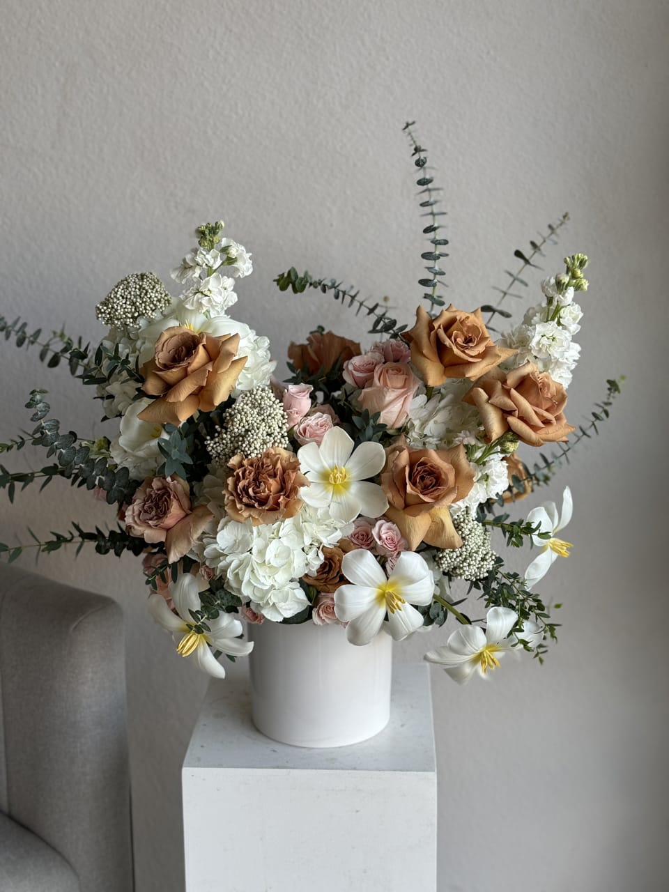 Coffee Sky mixed Arrangement  - The Coffee Sky Mixed Arrangement is a captivating blend of rich brown tones and soft, pastel hues, creating a harmonious balance reminiscent of a serene morning sky. This arrangement features a variety of premium flowers, including deep brown coffee-colored roses, delicate blue hydrangeas, elegant orchids, and charming spray roses, all elegantly complemented by lush green foliage. Perfect for any occasion, the Coffee Sky Mixed Arrangement brings a touch of sophistication and tranquility to your space.