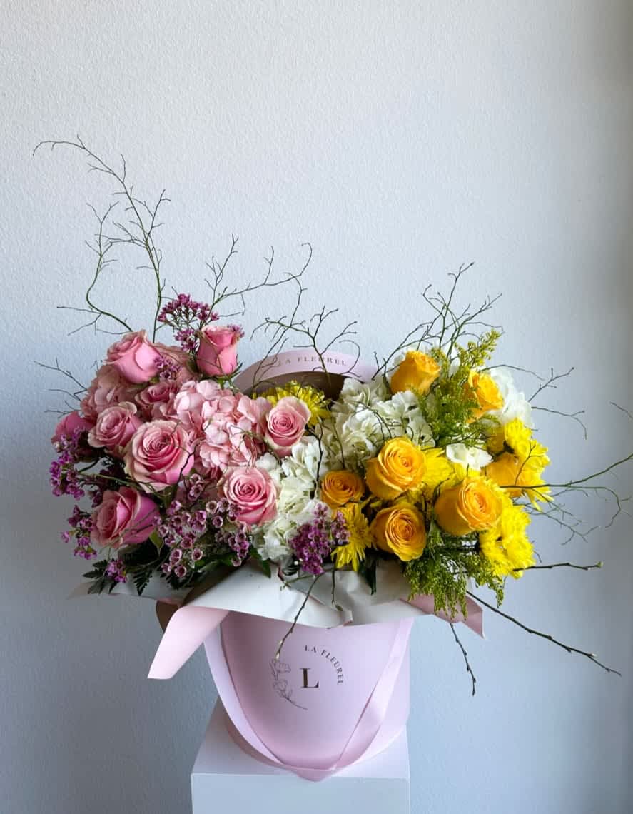 Yellow and Pink Arrangement - This beautiful arrangement is filled with yellow and pink roses, hydrangeas, and greens to deliver your special message to your special someone.  Perfect for any occasion. You can choose any color of the box.  Arrangement includes: Flowers Medium box  Custom greeting card